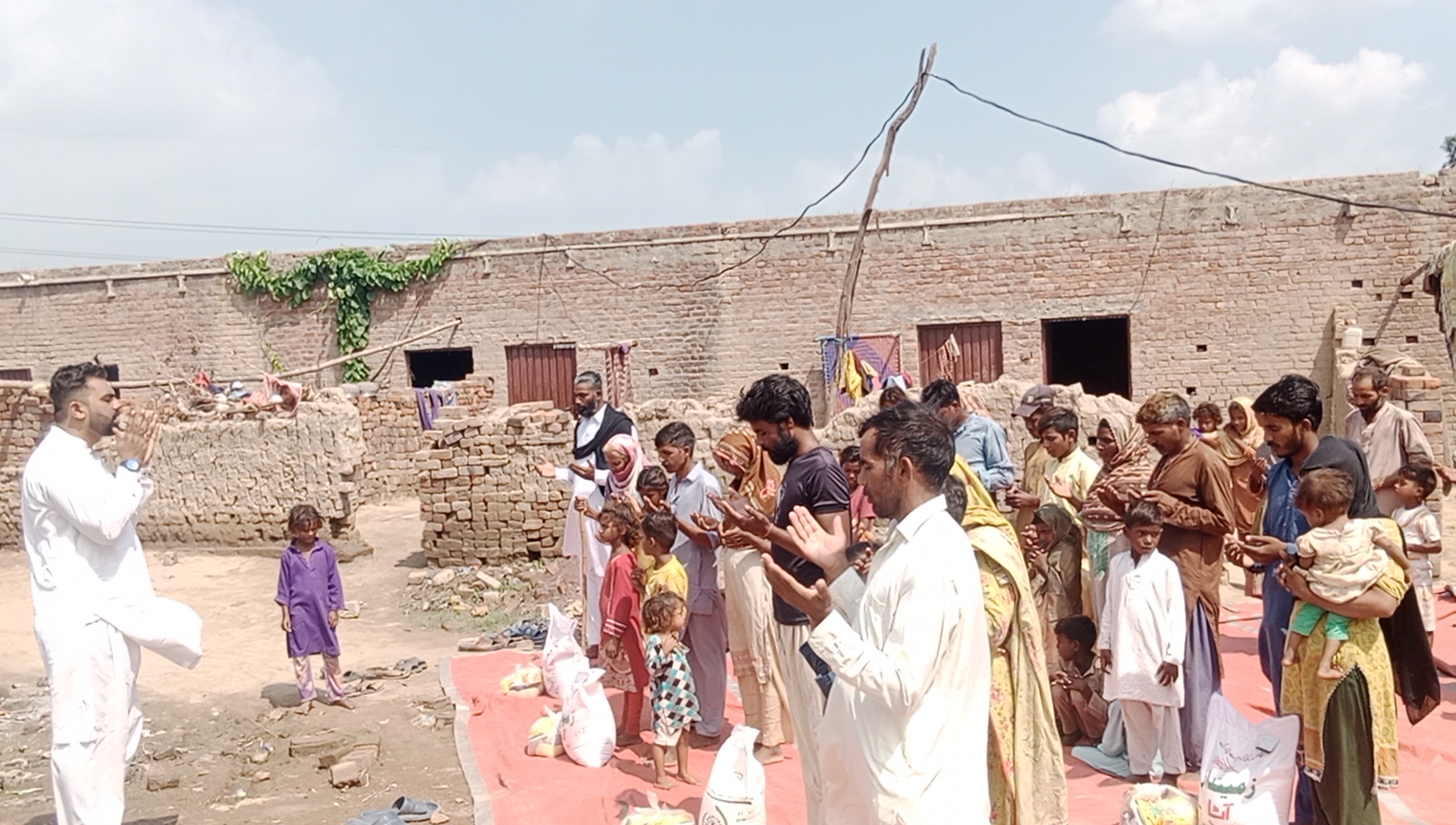A whole brick kiln community gathered for prayer as a month of groceries is given to every family