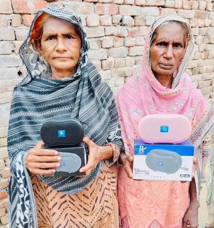 A family of three receiving Audio Bibles at their home in Pakistan