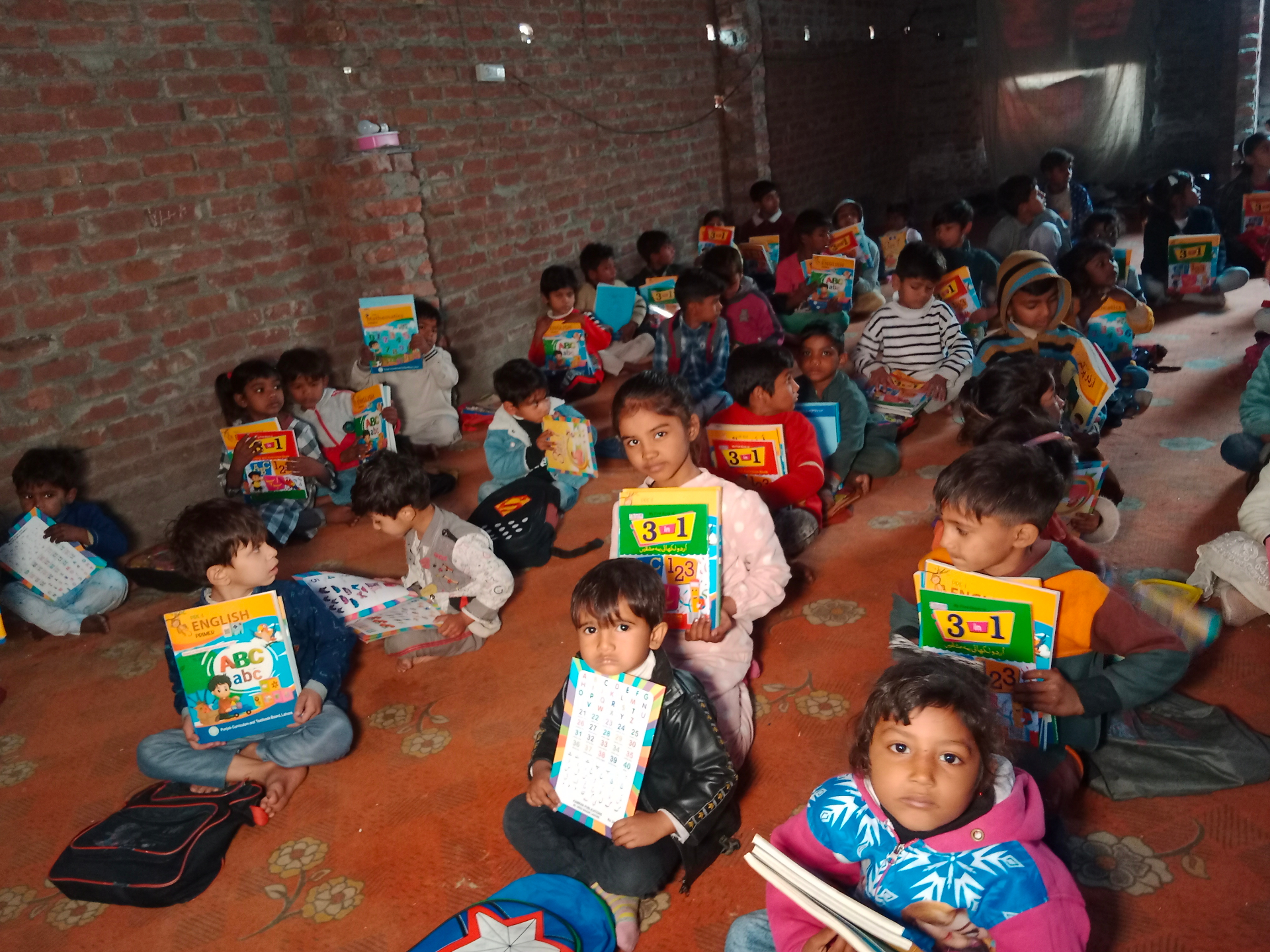 Classroom of children holding books and notebooks