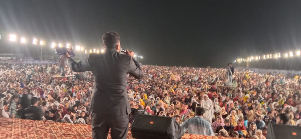 Open Bible raised over a crusade crowd