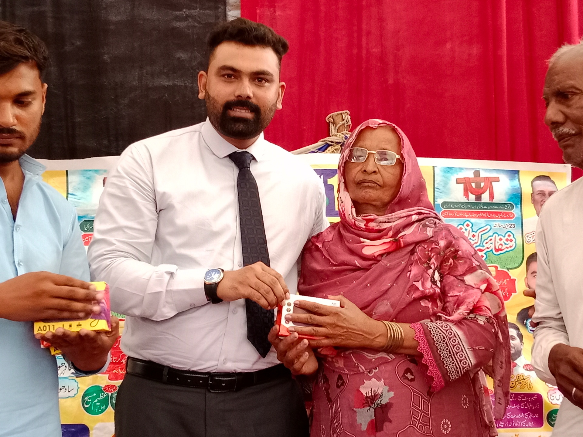 Pastor Shahzad giving an Audio Bible to an elderly woman
